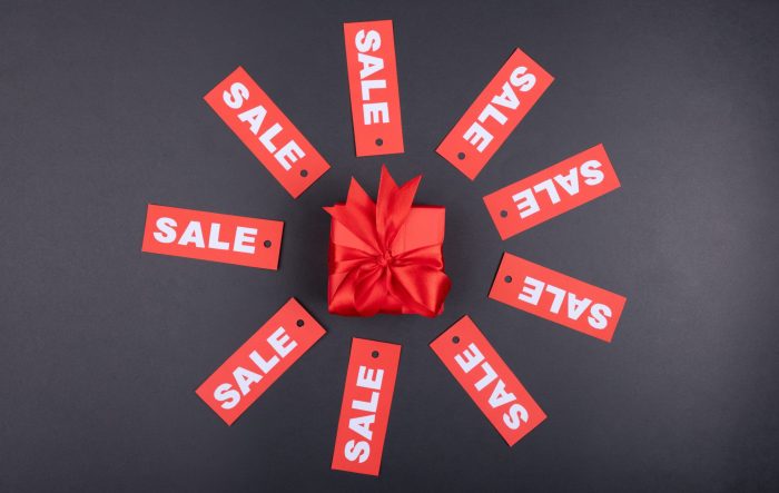 Boxes with 'sale' written on them, representing coupon code distribution through landing pages."
